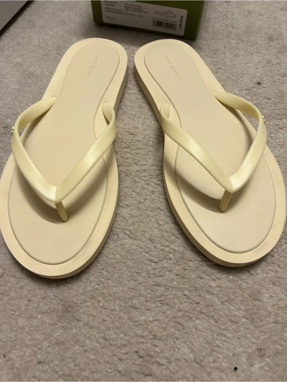 TORY BURCH KIRA padded flip flops in light yellow.